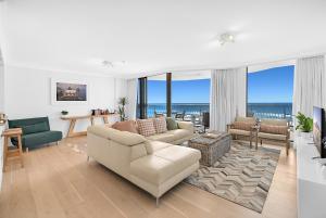 a living room with a couch and a table at Albatross North Apartments in Gold Coast