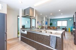 a kitchen with a sink and a living room at FuranoSky - Blue in Furano
