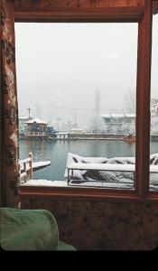 a window with a view of a body of water at Hb nancy group of houseboats in Srinagar