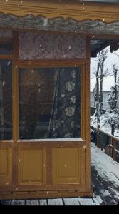 una finestra su un edificio nella neve di Hb nancy group of houseboats a Srinagar