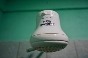 a close up of a hair dryer hanging from a wall at Hilltop Horizon Guesthouse in San Ignacio