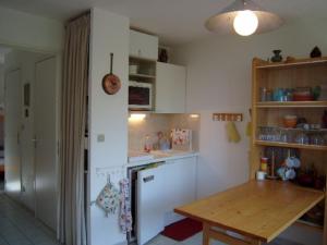 a kitchen with a wooden table and a counter top at Studio Crest-Voland, 1 pièce, 4 personnes - FR-1-733-153 in Crest-Voland