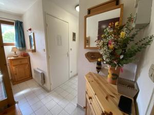 a kitchen with a vase of flowers on a counter at Studio Crest-Voland, 1 pièce, 4 personnes - FR-1-733-153 in Crest-Voland