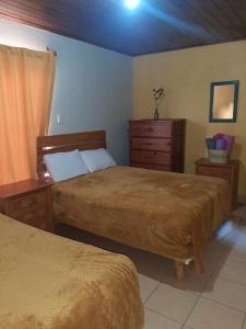 Ένα ή περισσότερα κρεβάτια σε δωμάτιο στο Posada Casa del Abuelo