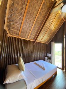 a bedroom with a bed with a wooden ceiling at KADIJ Guest House in San Juan