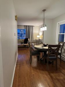 a dining room and living room with a table and chairs at Charming and Convenient 3br 1ba apt - fully furnished and equipped - fast Internet in Forest Park