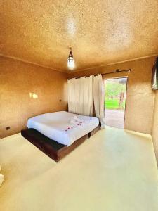 a bedroom with a large bed with a window at Whisper in Marrakech