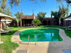 a swimming pool in the yard of a house at Whisper in Marrakech