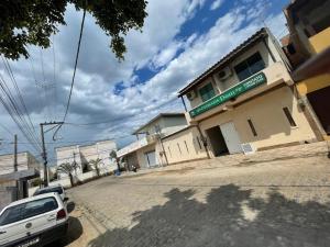 a car parked in front of a building on a street at Apto Light pulse in Campos dos Goytacazes