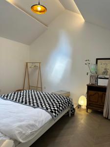 a bedroom with a bed with a black and white blanket at Shanghai Hills & CoZy Polar B&B in Shanghai