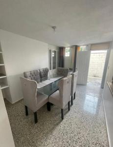 a dining room with a table and chairs and a mirror at Casa Blanca in Santo Domingo