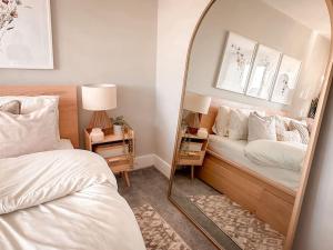 a bedroom with two beds and a mirror at Grand Union Apartment in Leicester