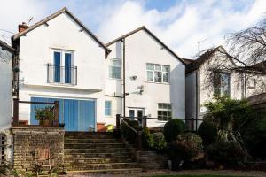 a white house with a blue garage at Gilmoreton House in Leicester