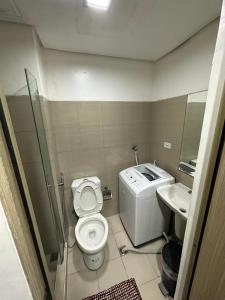 a small bathroom with a toilet and a sink at ARISE shell Residences in Manila
