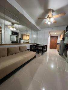 a living room and kitchen with a couch and a table at ARISE shell Residences in Manila