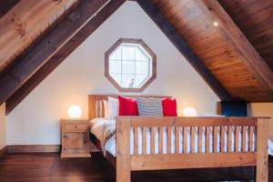 a attic bedroom with a bed and a window at Sunset on Tremblant with Sauna and Spa in Lac-Superieur