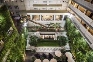 an overhead view of a courtyard in a building with plants at Rex Hotel in Ho Chi Minh City