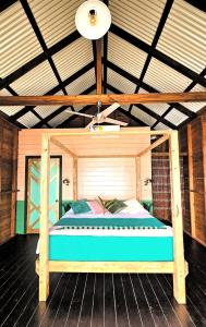 a bed in the middle of a room at The Sea Monkey in Bocas del Toro