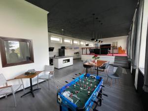 a kitchen and living room with a table with a chessboard on it at Ecolodge Loft in Oesterdeichstrich