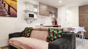 a living room with a couch and a kitchen at La Sérénade - TOP Destination - Montreuil in Montreuil