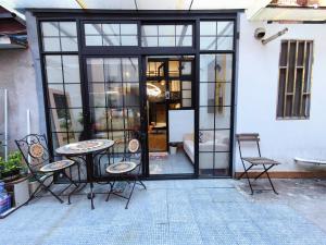 a patio with a table and chairs and a building at Shanghai Hills & Zinn Happy Family Bnb in Shanghai