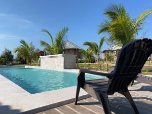 a black chair sitting next to a swimming pool at Sekepeng Penarek II in Kampung Penarik
