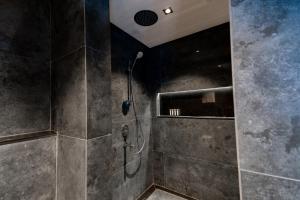 a bathroom with a shower with a shower head at Damask Hotels in Al Hada