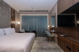 TV a/nebo společenská místnost v ubytování Damask Hotels