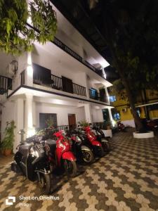 a row of motorcycles parked in front of a building at Sabinas Goa in Saligao