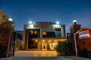a building with lights on top of it at night at Hotel Ramleela in Rāmeswaram