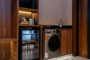 a kitchen with a washing machine and a sink at Damask Hotels in Al Hada