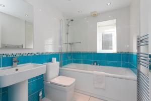 a bathroom with a tub and a toilet and a sink at Chy Lowen in Carbis Bay +32 photos
