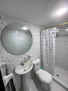 a bathroom with a toilet and a sink and a shower at Apto 301 / Av. Las Lajas in Ipiales