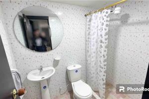 a bathroom with a toilet and a sink and a mirror at Apto 301 / Av. Las Lajas in Ipiales