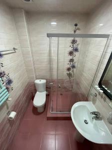 a bathroom with a shower and a toilet and a sink at Olympic Hotel in Gyumri