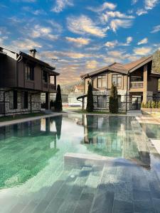 a swimming pool in front of a house at V Chalet Residence in Velingrad