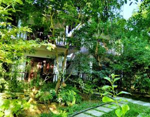 a house with a garden in front of it at Heaven in Satinwoods in Tangalle