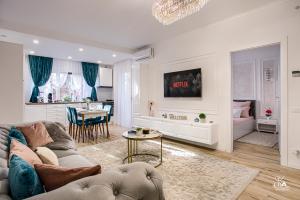 a living room with a couch and a table at Sika Garden Apartment - cazare Arad - self check-in in Arad