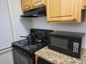 a kitchen with a stove and a microwave at kaysgroove in Alexandria