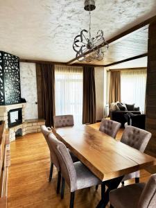 a dining room with a wooden table and chairs at V Chalet Residence in Velingrad