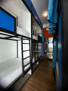 a group of bunk beds in a room at Revolution Chiang Mai - Old Town in Chiang Mai
