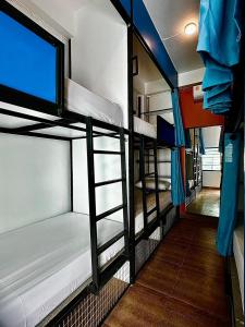 a group of three bunk beds in a room at Revolution Chiang Mai - Old Town in Chiang Mai