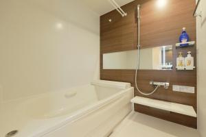 a bathroom with a bath tub and a sink at EveryNet ShinjukuⅡ in Tokyo