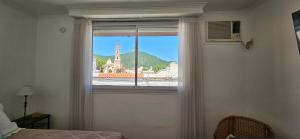 a window in a bedroom with a view of a castle at Departamento temporario en Salta la Linda in Salta