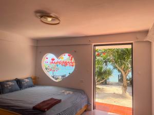 a bedroom with a heart mural on the wall at Bãi Xếp Beach in Quy Nhon