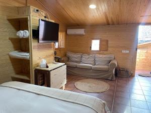 a bedroom with a bed and a couch in a room at Cal General in San Vicente de Castellet +14 photos