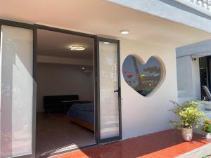 a glass door with a heart on the wall at Bãi Xếp Beach in Quy Nhon
