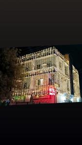 a lit up building with christmas lights on it at Hotel Swastik Palace in Maheshwar