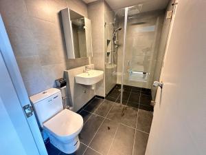 a bathroom with a toilet and a sink and a shower at JQ1 SEA & POOL or CITY View WIFI I WASHING MACHINE for Seaview unit I CUCKOO WATER Jesselton Quay by R2 in Kota Kinabalu