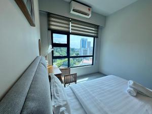 een slaapkamer met een bed en een groot raam bij JQ1 SEA & POOL or CITY View WIFI I WASHING MACHINE for Seaview unit I CUCKOO WATER Jesselton Quay by R2 in Kota Kinabalu